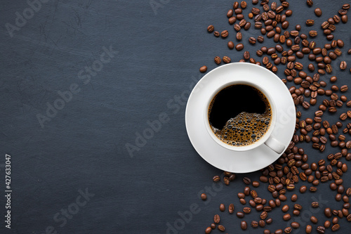 hot coffee and bean on wooden table background. mockup and templates to create greeting, cards, magazines, cover, poster and banners etc. space for text. top view. flat lay