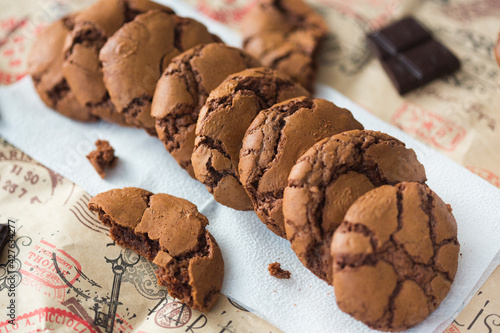 Homemade chocolate cookies brookies on white paper napkin and dark chocolate slices photo