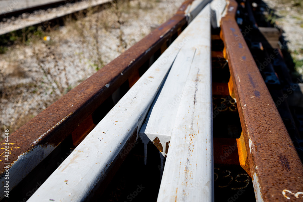 Obraz premium New railway junction lines ready to place. Railway rails painted white. Close up