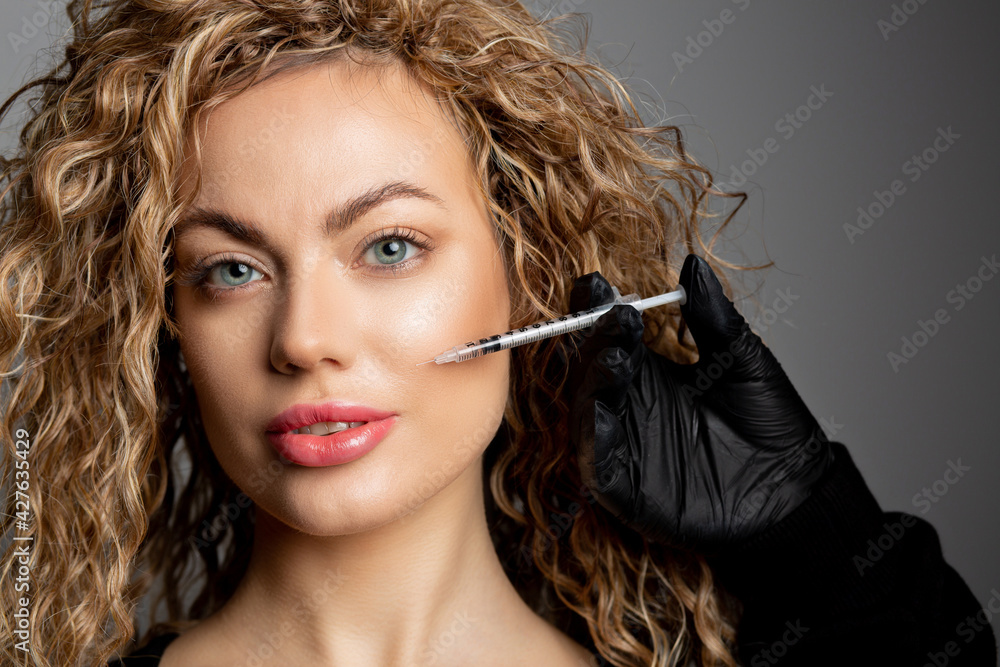 Obraz premium Adorable woman with curly hair having anti aging injection