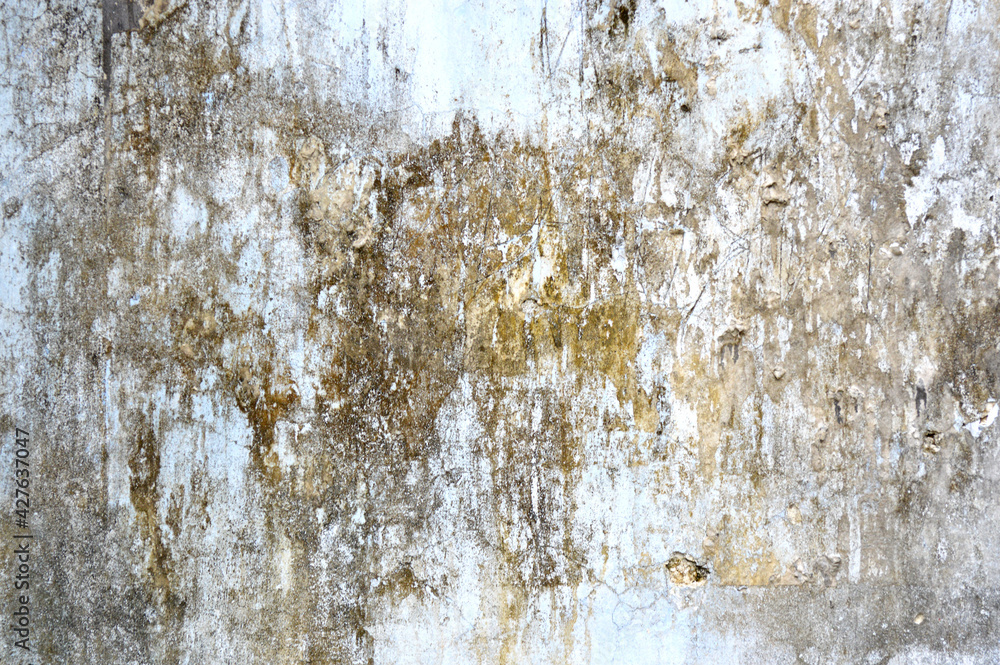 Obraz premium Concrete grey wall with ols cracked paint. Yellow, grey, white and beige colors. Abstract photo background. Urban style texture. Building exterior. Cement unique and attractive textures
