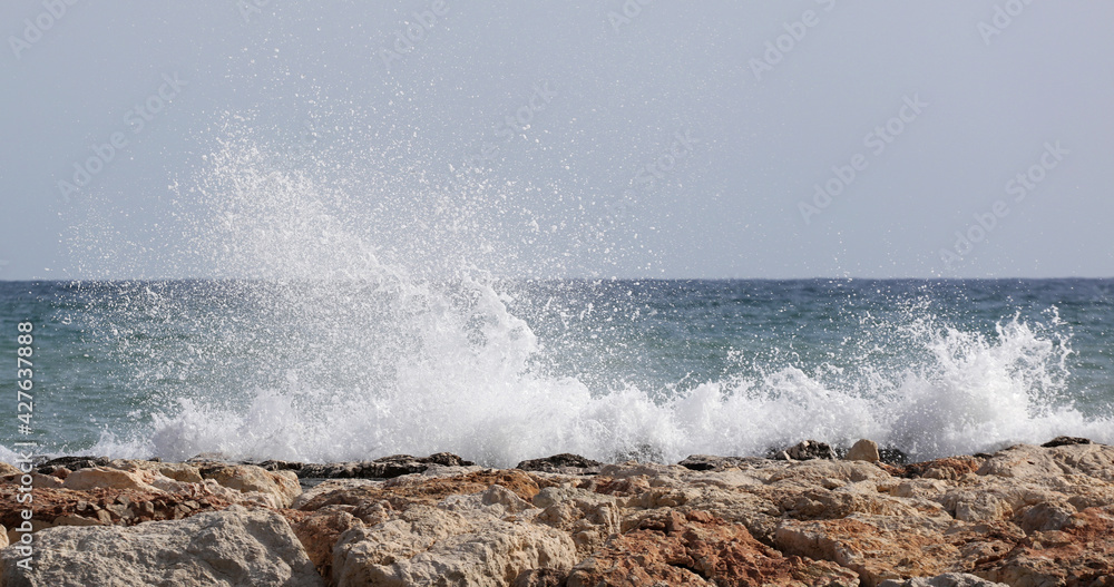 Beautiful waves crashing on rocks in the Bay