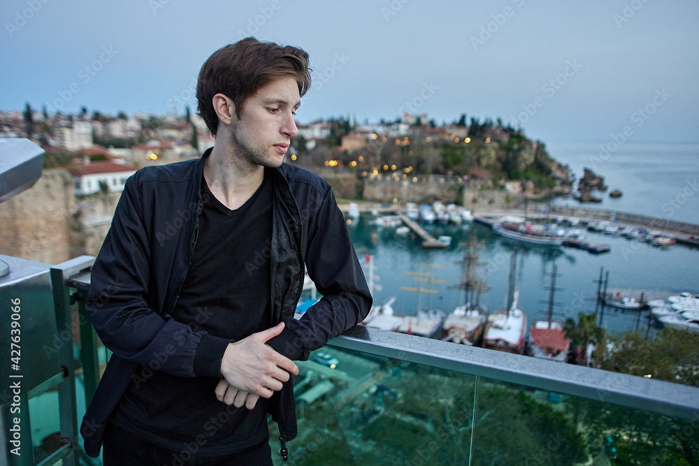 Portrait of an independent European solo tourist near sea at sunset in Antalya, Turkey. Portrait of an independent European solo tourist near sea at sunset in Antalya, Turkey.