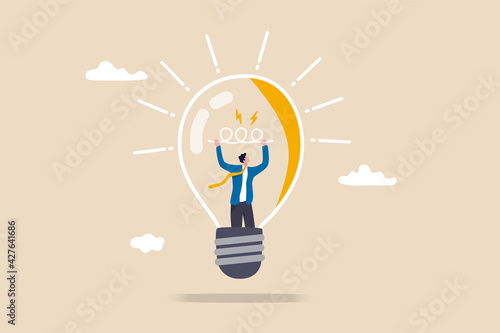 Entrepreneurship, curiosity and creativity to create new idea, motivation to success or problem solving concept, smart businessman go inside light bulb to fix or invent new idea light up bright. photo