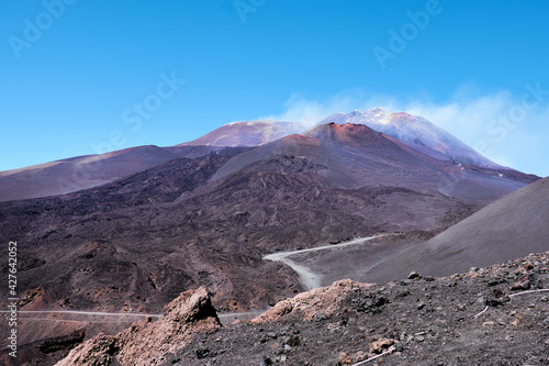Mount Etna in Sicily near Catania, Tallest active Europe volcano in Italy. Red and purple lava fields around one of the craters. © tilialucida
