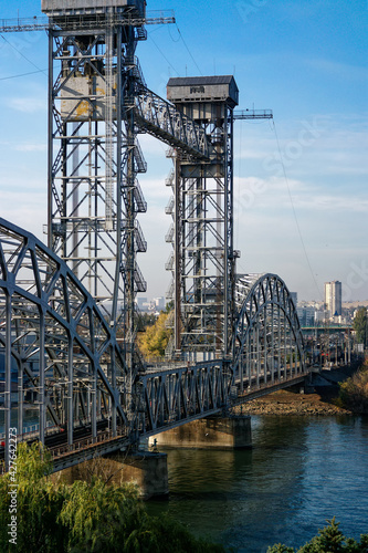 View of the old railway bridge made of metal structures over the river
