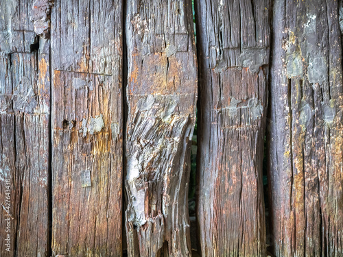 Weathered solid wood vertical planks of Old house fence, Close up background texture.