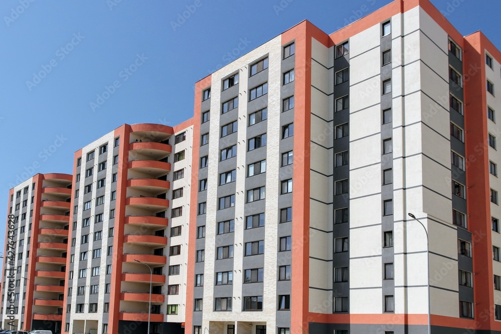 Modern construction work of new residential buildings under a blue sky