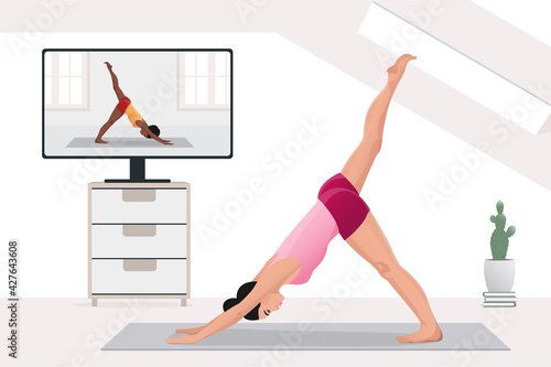 woman watch and repeat yoga education, practicing stretching at home with instructor by video on TV on Internet online