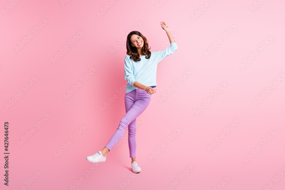Full length body size view of charming cheerful fit wavy-haired girl dancing having fun isolated over pink pastel color background