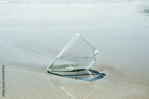 rectangular reusable water bottle on the seashore