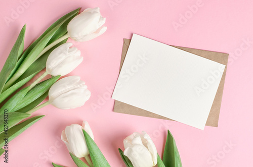 Fototapeta Naklejka Na Ścianę i Meble -  Greeting card ith white tulip flowers bouquet on pink paper background