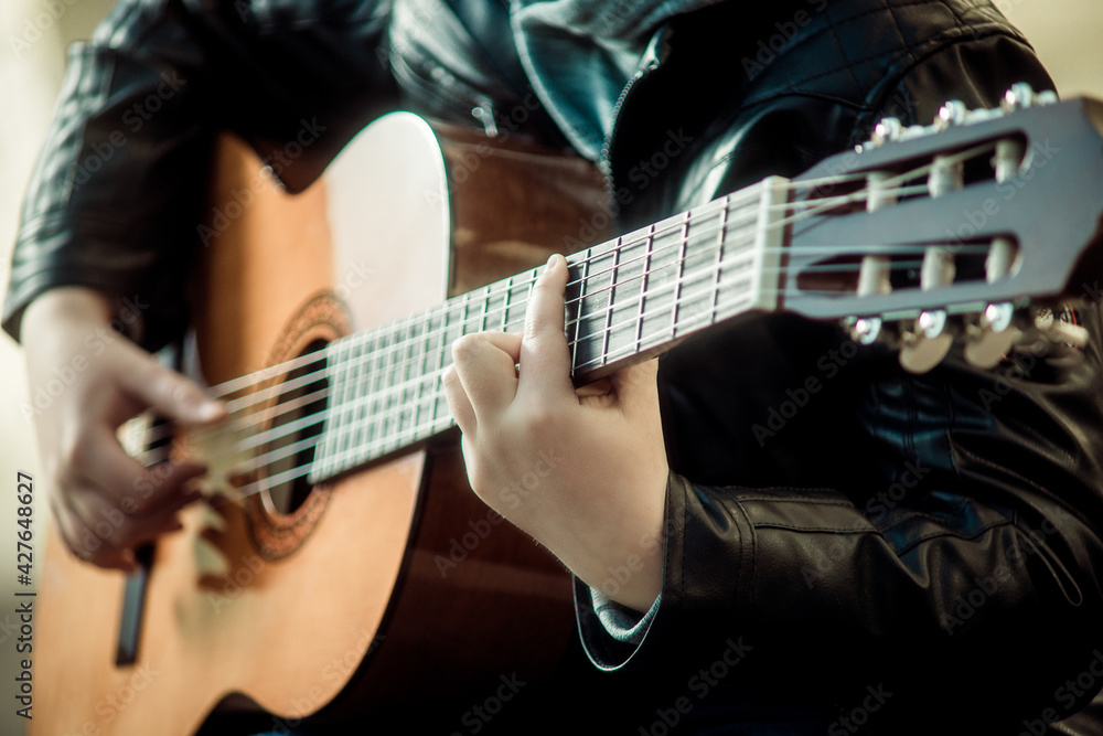 child playing guitar close up