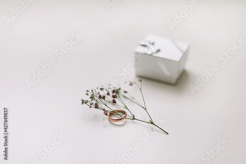 Fototapeta Naklejka Na Ścianę i Meble -  Golden ring and jewelry box and flowers. Wedding, Love, Valentine's day, Happy Birthday, Proposal of marriage concept