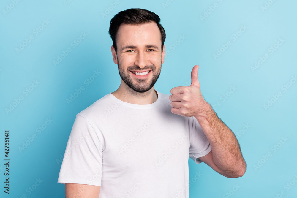 Portrait of attractive cheerful glad successful guy showing thumbup agree isolated over blue bright pastel color background Portrait of attractive cheerful glad successful guy showing thumbup agree isolated over blue bright pastel color background