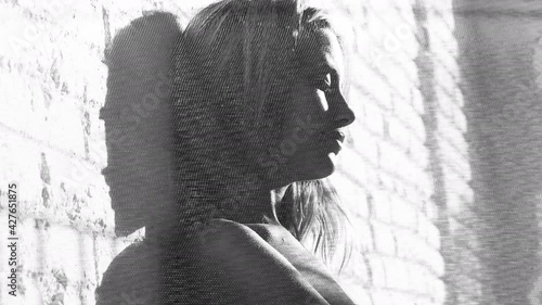 woman posing agaisnt brick wall glitching