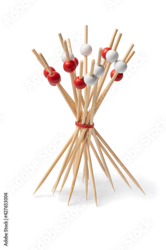 Bunch of festive red and white cocktail sticks isolated on white background 