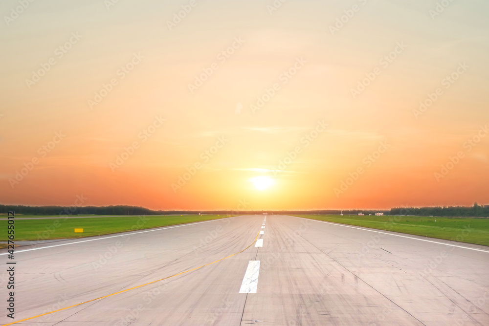 Fototapeta premium Empty runway with morning sunrise light firmament.