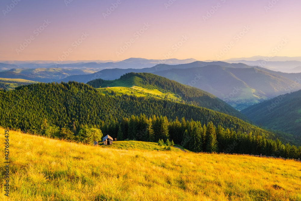 View of a mountains range. Landscape during sunset at the summer time. Foggy hills in the mountains ragion. Travel image. Spring landscape.