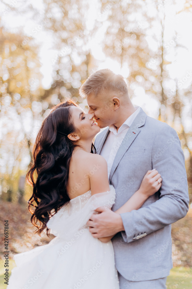 Portrait of happy newlyweds hugging, smiling and looking at each other. Concept of wedding couple Portrait of happy newlyweds hugging, smiling and looking at each other. Concept of wedding couple