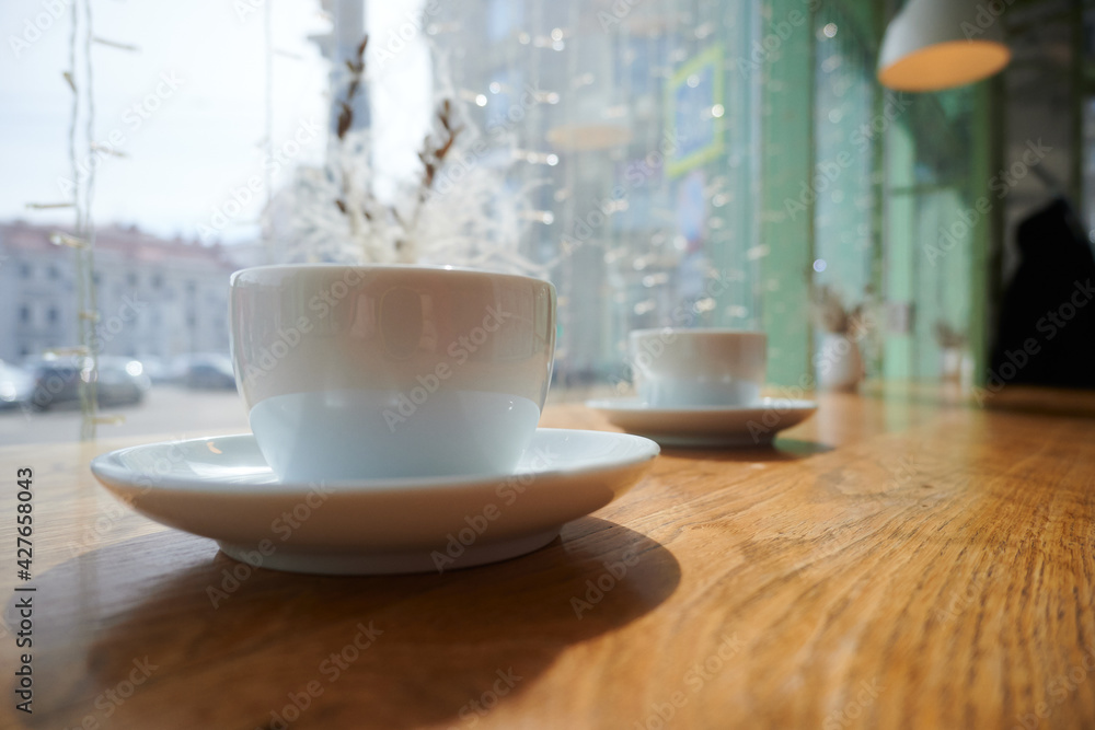 Mugs with coffee on a wooden table with blurred background Mugs with coffee on a wooden table with blurred background