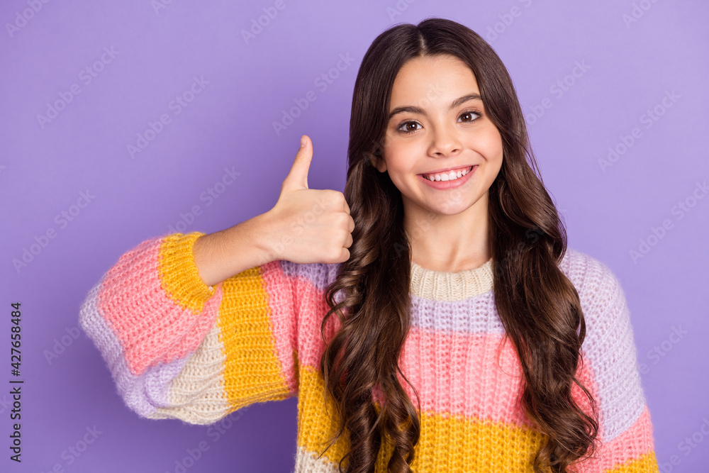 Photo of young girl happy positive smile show thumb-up like cool advert choice choose isolated over violet color background Photo of young girl happy positive smile show thumb-up like cool advert choice choose isolated over violet color background