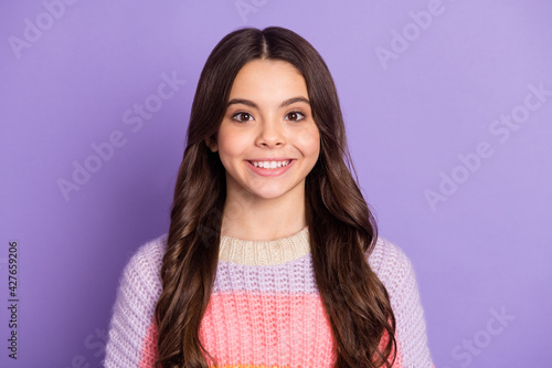 Photo of young attractive schoolgirl happy positive smile brown curly hair isolated over purple color background