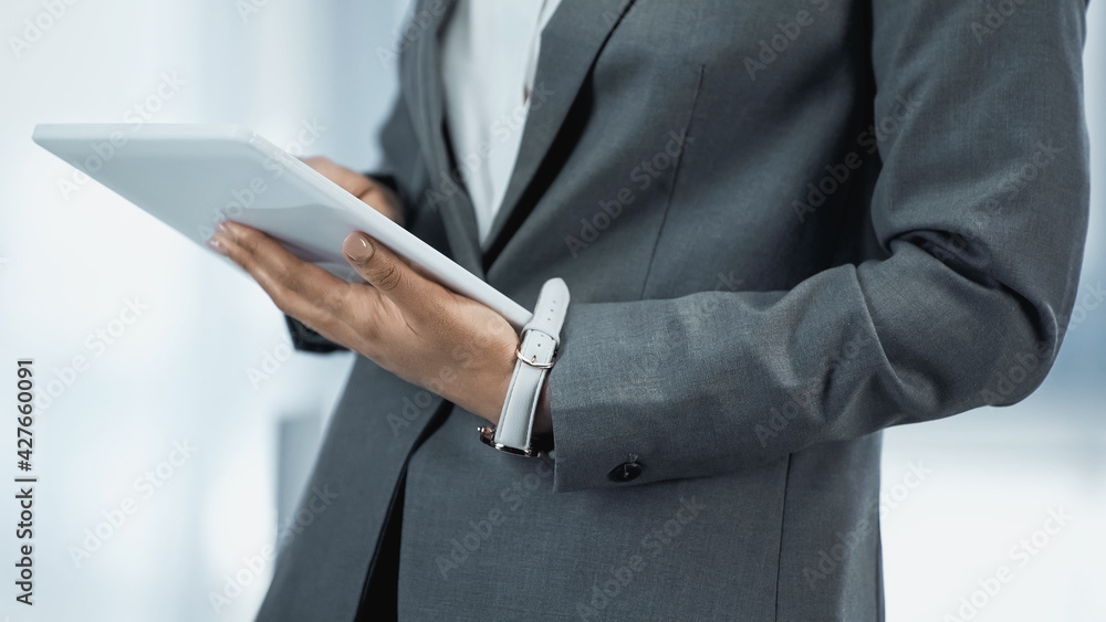 cropped view of african american businesswoman using digital tablet cropped view of african american businesswoman using digital tablet