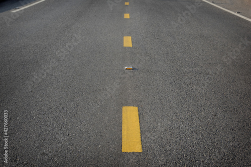 Closeup asphalt road with marking lines for separate lane