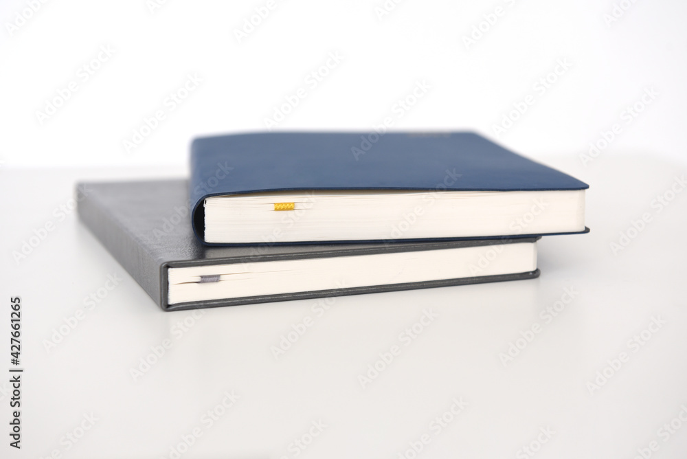two paper notebooks with a cover on a white background two paper notebooks with a cover on a white background