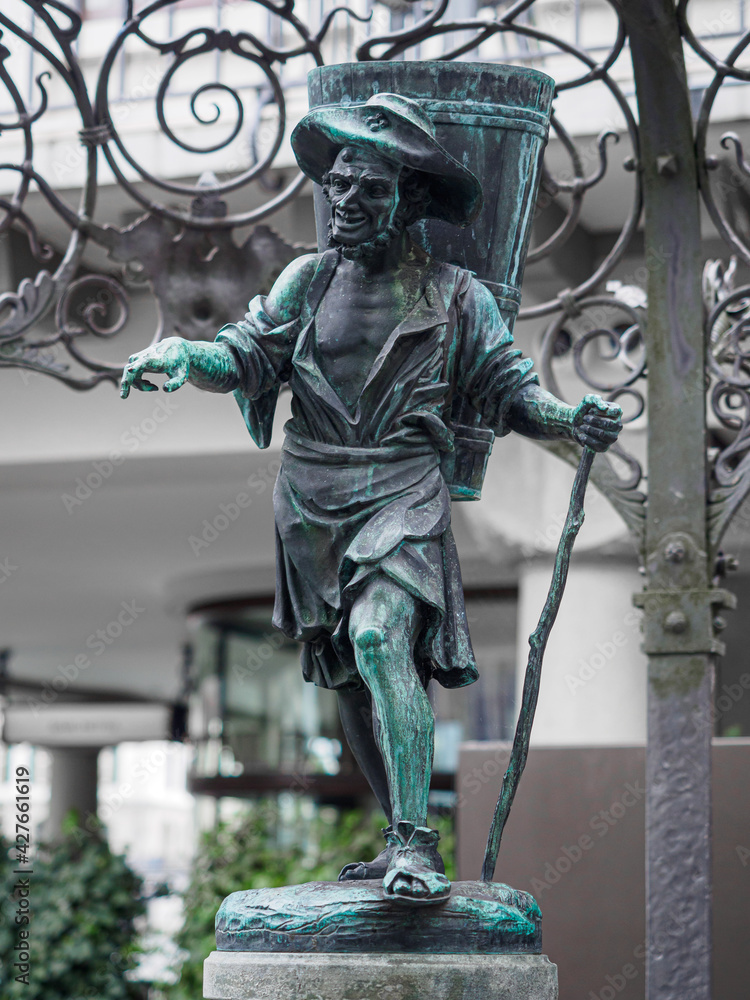 Sculpture of winemaker as a part of fountain on Weinplatz square in Zurich, Switzerland