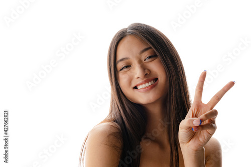 Young asian happy woman smiling and showing peace sign