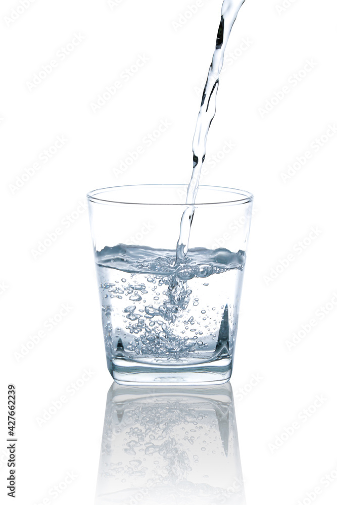 Pour drinking water into a clear, square glass with a few air bubbles.with Clipping Path. Pour drinking water into a clear, square glass with a few air bubbles.with Clipping Path.