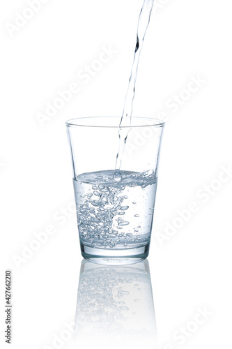 Pour drinking water into a clear glass.with Clipping Path.