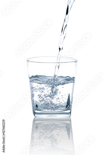 Pour drinking water into a clear, square glass with a few air bubbles.with Clipping Path.