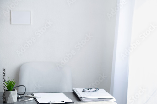 Empty doctor workplace, hospital office on light background, doctor desk