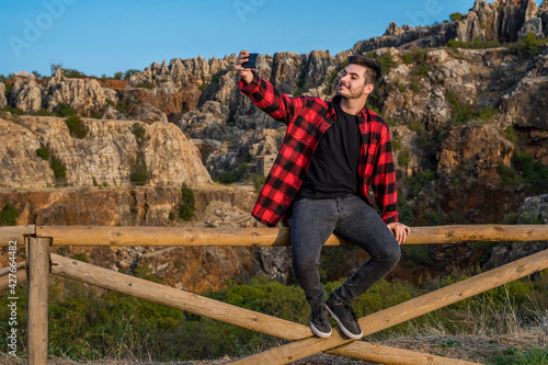 Young Caucasian man taking happy selfies in Sierra Norte Cazalla, Spain photo