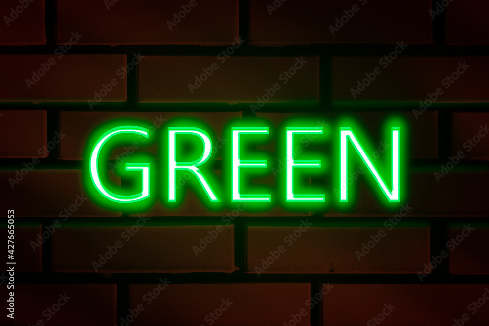 Neon lettering - GREEN on a red brick wall. Neon lettering - GREEN on a red brick wall.