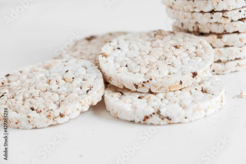 Round diet crispbreads on a white background. Round shaped cereal bread, healthy food without yeast. Copy, empty space for text