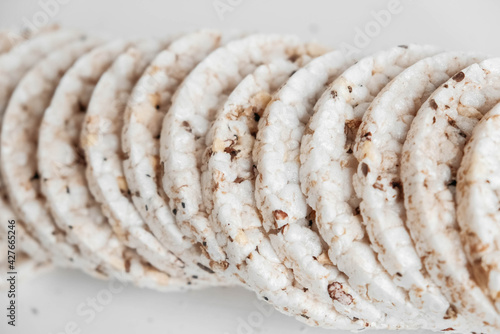 Round diet crispbreads on a white background. Round shaped cereal bread, healthy food without yeast. Top view. Copy, empty space for text