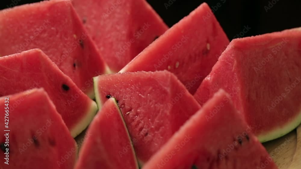 Slices of Ripe Watermelon on a Plate. Triangular watermelon slices slowly rotate. Healthy food concept. Slices of Ripe Watermelon on a Plate. Triangular watermelon slices slowly rotate. Healthy food concept.