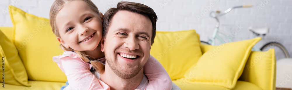 happy girl embracing smiling father at home, banner happy girl embracing smiling father at home, banner