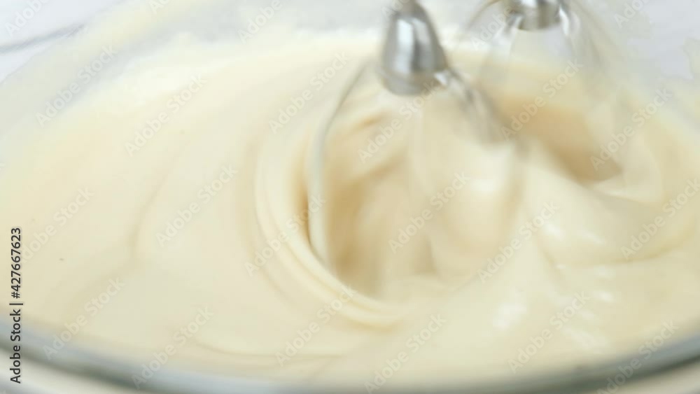 pastry chef use handmixer mixing meringue for cake and bakery. pastry chef use handmixer mixing meringue for cake and bakery.