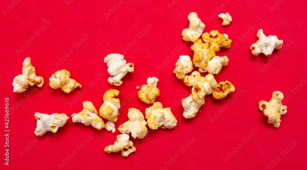 Close-up of popcorn on a red background. Close-up of popcorn on a red background.