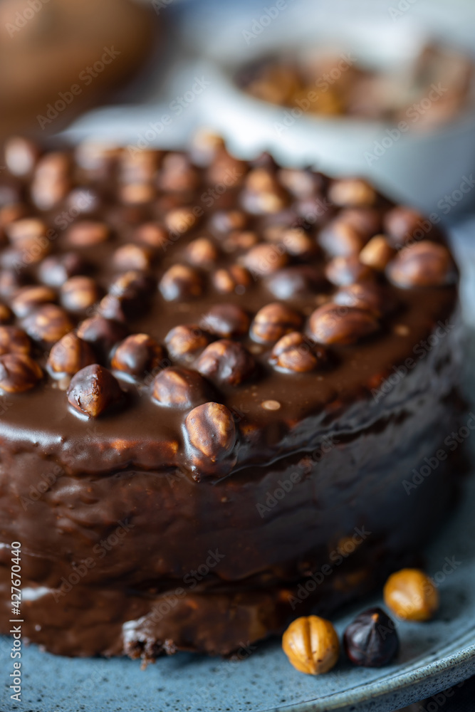 Homemade cold chocolate cake with hazelnuts, chocolate dessert background, close up, selective focus
