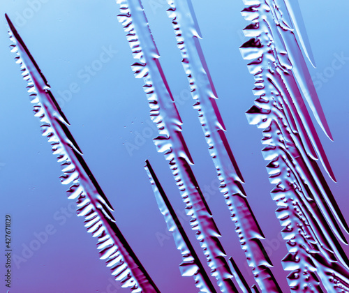 Fototapeta Naklejka Na Ścianę i Meble -  Blue-pink patterns from frost on glass as a background.