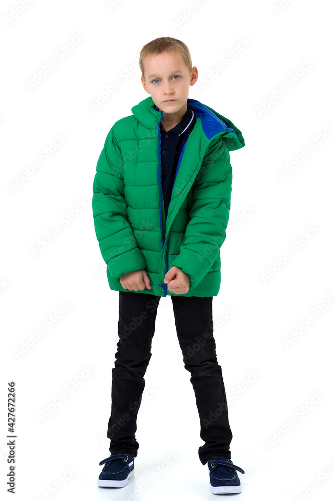 Naklejka premium Smiling boy in unbuttoned green winter jacket