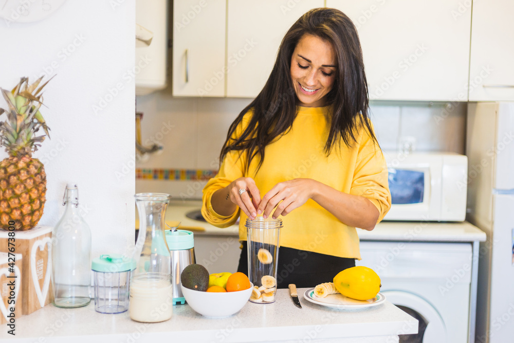 Young beautiful woman preparing a healthy smoothie Young beautiful woman preparing a healthy smoothie