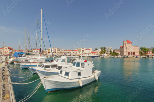 Port of charming Aegina town with yachts and fishermen boats docked in Aegina island, Saronic gulf, Greece, in a sunny summer morning © Aron M  - Austria