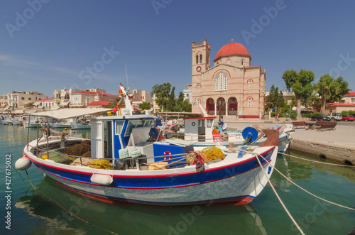 Port of charming Aegina town with yachts and fishermen boats docked in Aegina island, Saronic gulf, Greece, in a sunny summer morning